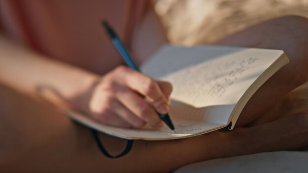 Photo hands writing personal journal in sunlight closeup calm girl rest morning bed