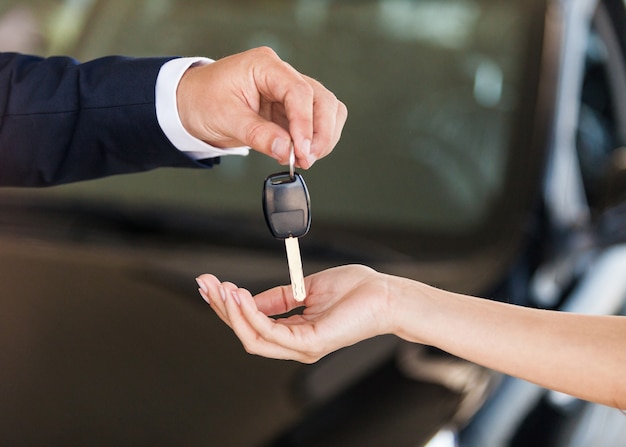 Hands of young couple with key