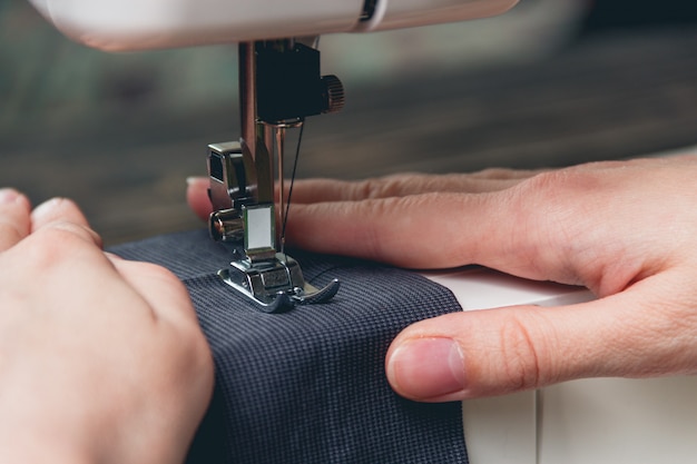 Hands of young girl on sewing machine