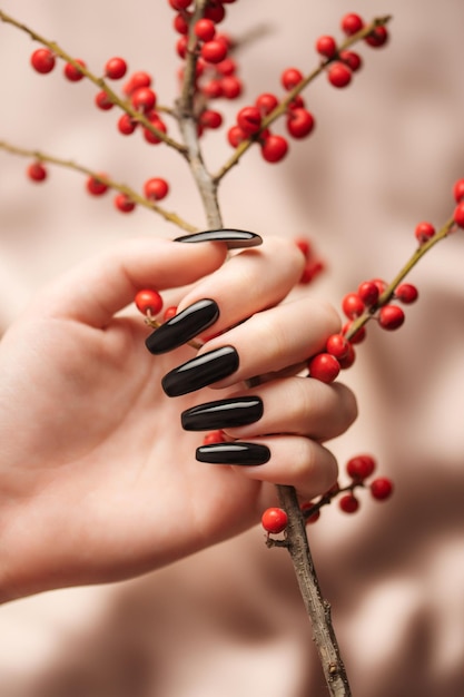 Hands of a young girl with black manicure on nails