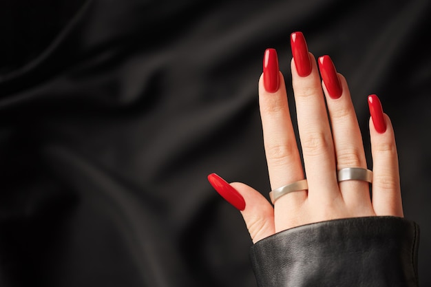 Hands of a young girl with red manicure on nails