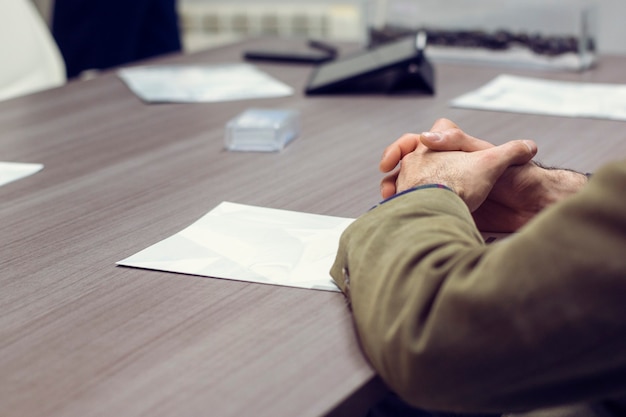 Hands of a young man in an office meeting with the business partners