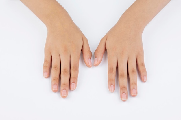 Hands of a young woman hand and nail care with white background and copy space