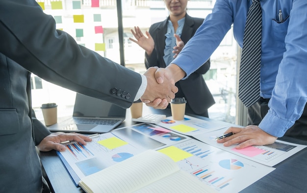 handshake after business team meeting to plan strategies to increase business income