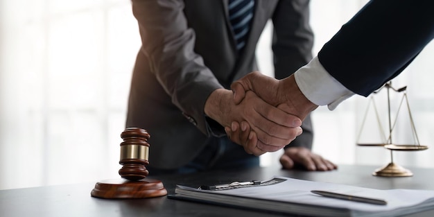 Handshake after cooperation between attorneys lawyer and clients discussing a contract agreement legal fighters Concepts of law advice