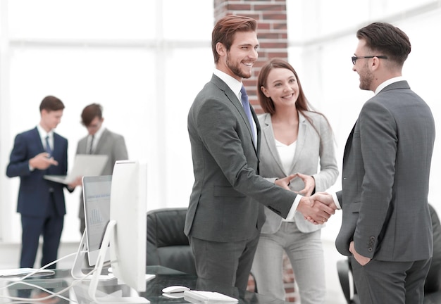 Handshake business partners at a meeting