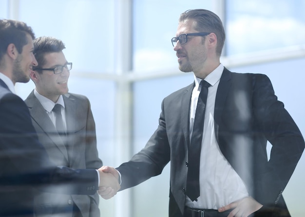 Handshake business partners in a modern office