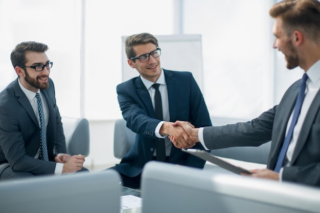 Handshake business partners at the negotiating table the concept of cooperation