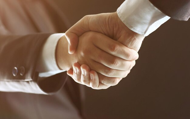 Handshake Hand holding in the black background