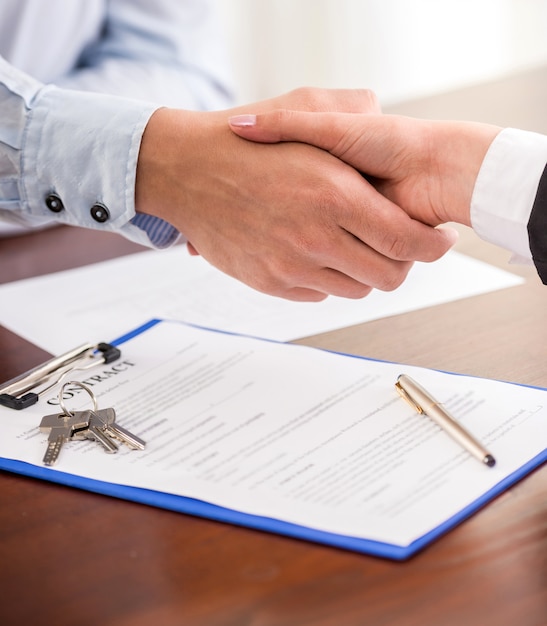 Handshake of a real estate agent and a client.