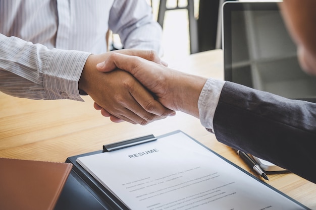 Handshake while job interviewing, candidate shaking hands with Interviewer after a job interview