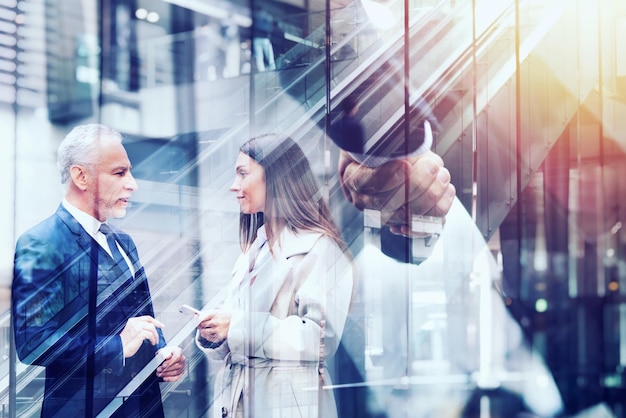 Photo handshaking business person in office concept of teamwork and partnership double exposure