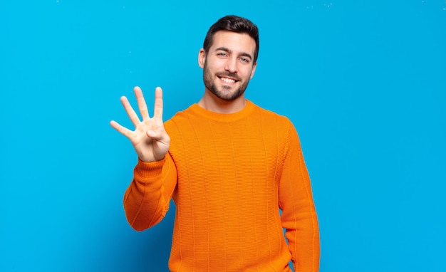 Handsome adult blond man smiling and looking friendly showing number four or fourth with hand forward counting down