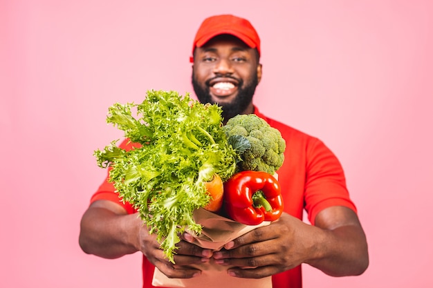  Handsome African American delivery man carrying package box of grocery food from store