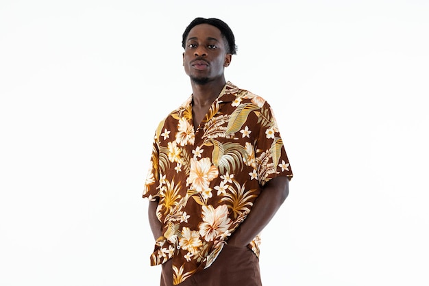 Handsome african american guy standing on white background in studio wearing colorful shirt