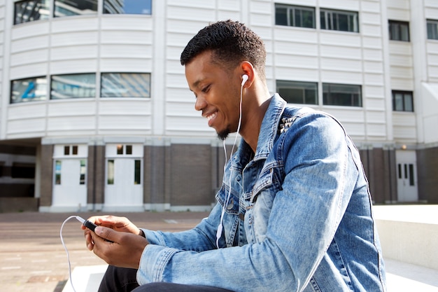 Handsome african man with smart phone and headphones