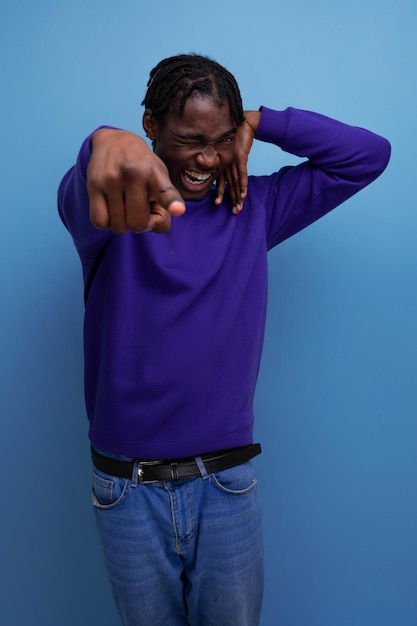 Handsome african young guy with dreadlocks smiling and joking