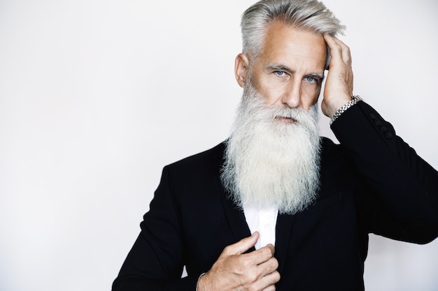 Handsome aged man wearing stylish black suit on white