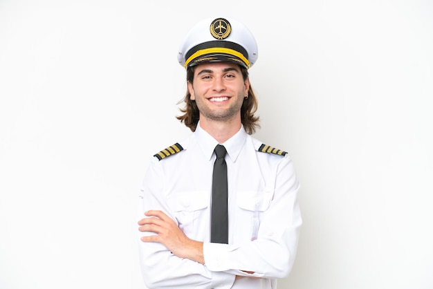 Handsome Airplane pilot isolated on white background keeping the arms crossed in frontal position