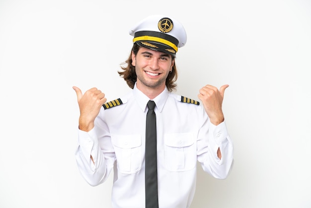 Handsome Airplane pilot isolated on white background with thumbs up gesture and smiling