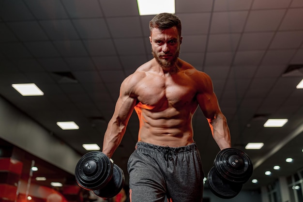 Handsome athletic man working out in gym Lifestyle bodybuider in gym