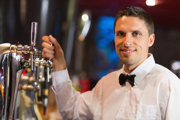 Handsome barman smiling at camera