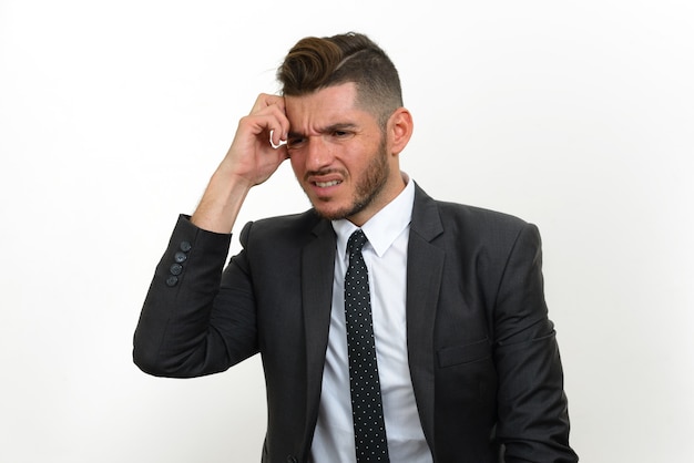 handsome bearded Hispanic businessman wearing suit on white