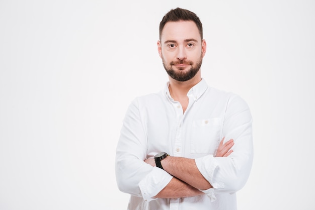 Handsome bearded man posing with arms crossed