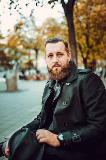 Handsome bearded man with mustache on the street. Movember concept