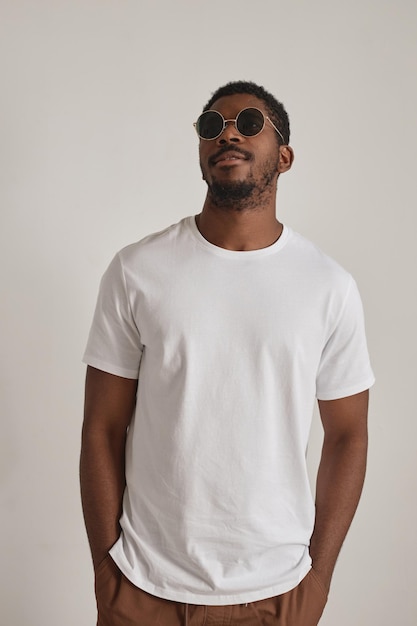 Handsome black man wearing sunglasses on white