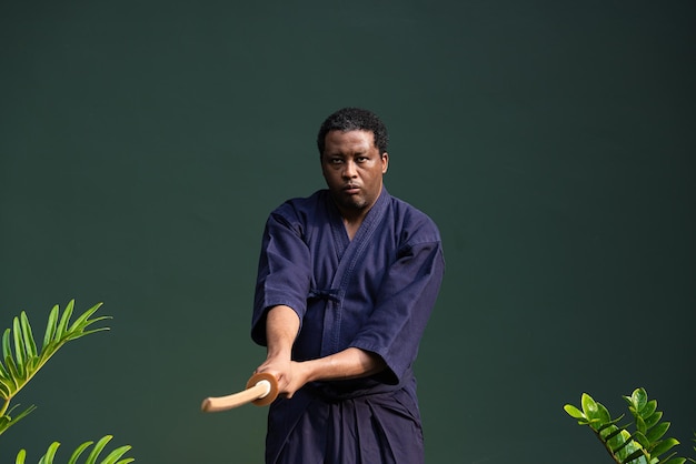 Handsome black martial artist man with martial arts costume of kendo