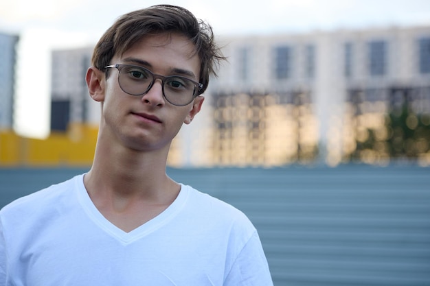 Handsome boy with glasses smiles at the camera