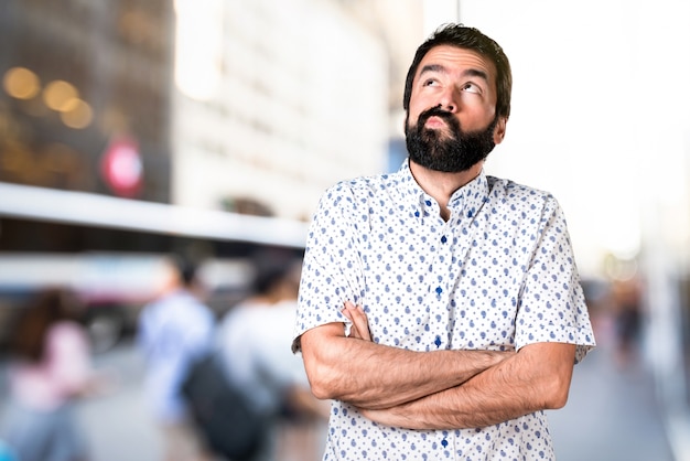 Handsome brunette man with beard having doubts