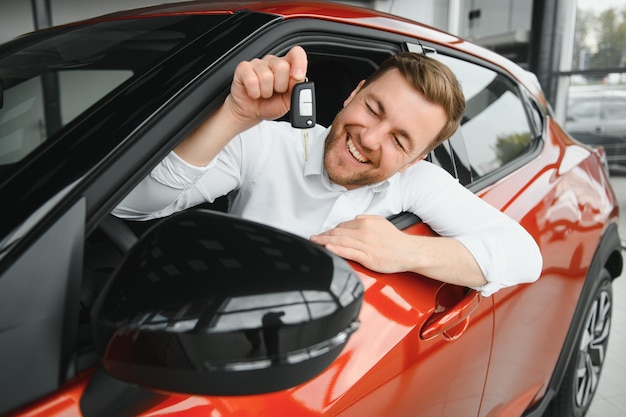 Handsome businessman driving car before buying