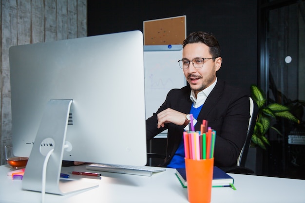 Handsome businessman enthusiastic office worker computer monitor