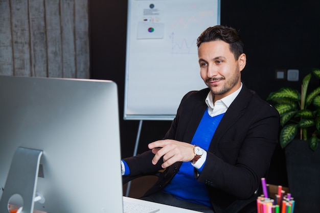 Handsome businessman enthusiastic office worker computer monitor