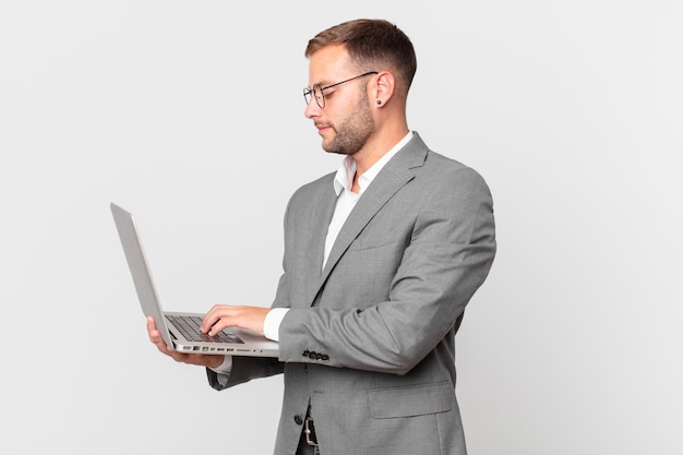 Handsome businessman holding a laptop