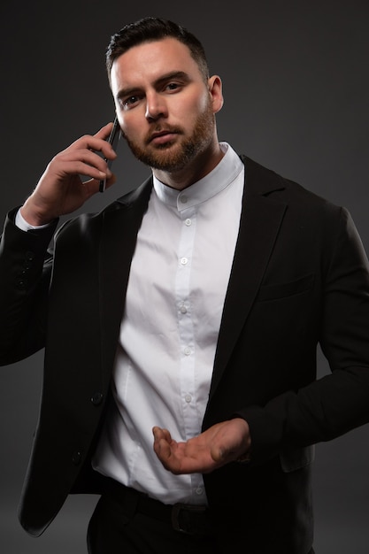 Handsome businessman in a suit talking on the phone.