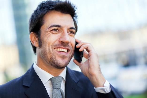 Handsome businessman talking on the mobile phone