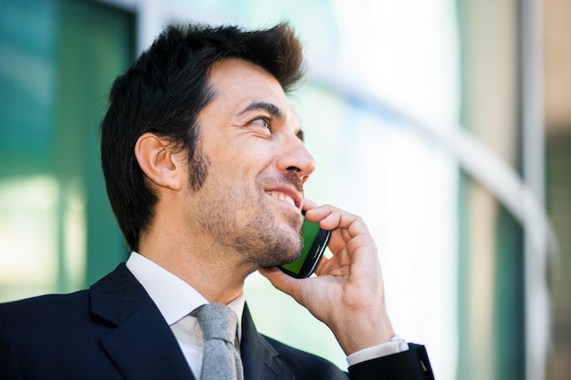 Handsome businessman talking on the mobile phone