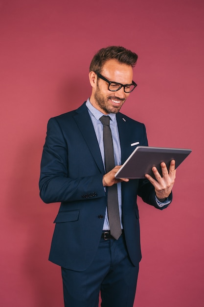 Handsome businessman working in a tablet