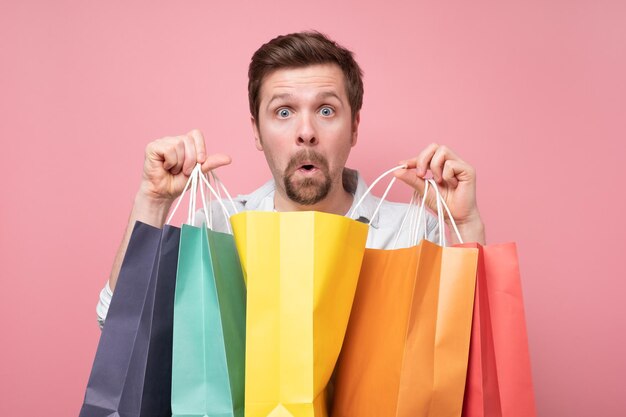 Handsome caucasian happy postive man with shopping bags