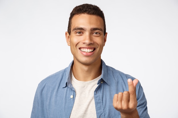 Handsome cheerful young man in blue shirt over t-shirt