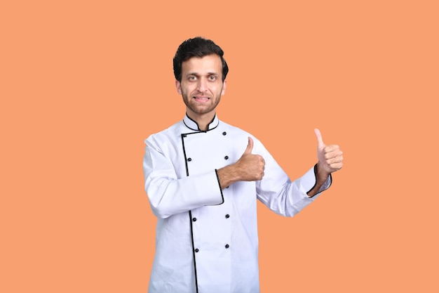 handsome chef cook front pose thumbs up white outfit indian pakistani model