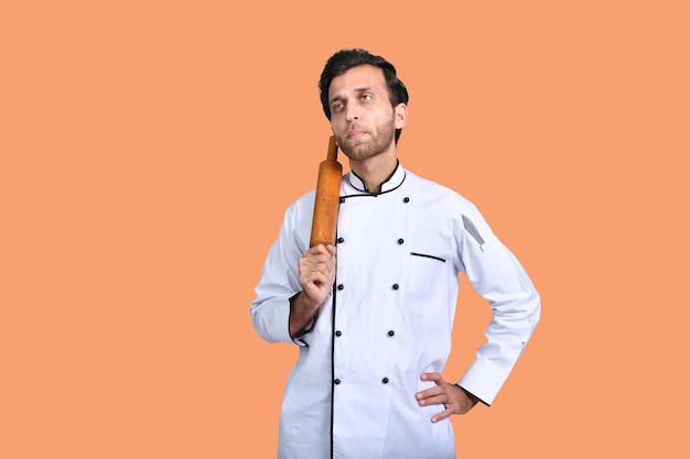 handsome chef cook holding rolling pin indian pakistani model