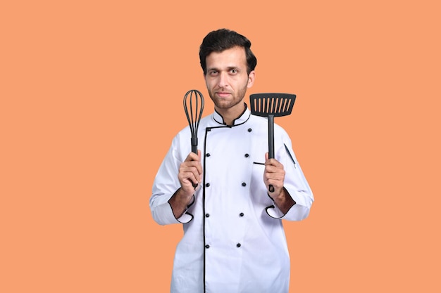 handsome chef cook white outfit having tools indian pakistani model