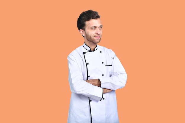 handsome chef cook white outfit isolated on orange background indian pakistani model