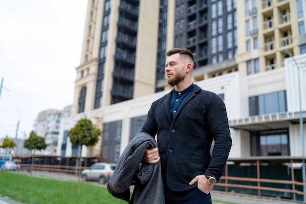 Handsome confident businessman on the city street Modern manager outdoor walking