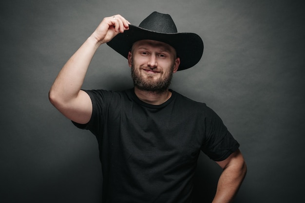 Handsome cowboy wearing black cowboy hat