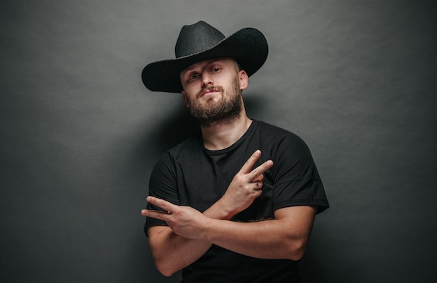 Handsome cowboy wearing black cowboy hat